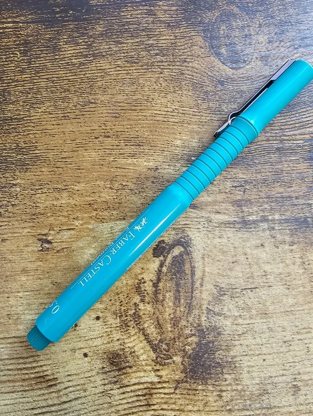 Faber-Castell Ecco Pigment fineliner blue pen with a turquoise barrel